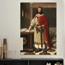 Load image into Gallery viewer, A portrait of a man dressed in red royal robes hangs on a white wall above a black table