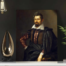 Load image into Gallery viewer, A portrait of a man with a mustache dressed in black royal clothes hangs on the dark wall next to a light bulb