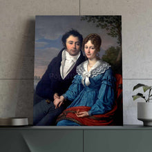 Load image into Gallery viewer, Portrait of a couple dressed in blue royal attires stands on a green table near a flowerpot