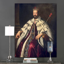 Load image into Gallery viewer, A portrait of a man dressed in regal attire with a crown hangs on a gray wall above books and a candle