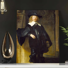 Load image into Gallery viewer, A portrait of a man with long hair dressed in black royal clothes with a hat stands on a white table