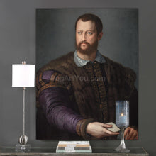 Load image into Gallery viewer, A portrait of a man dressed in historical royal attire with fur hangs on a gray wall above a candle

