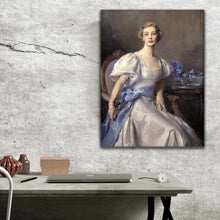 Load image into Gallery viewer, Portrait of a woman with blond hair dressed in regal attire hangs on a gray wall above a work table