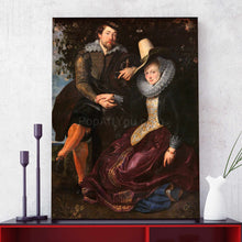 Load image into Gallery viewer, Portrait of a couple dressed in historical black clothes standing on a red table next to a white vase