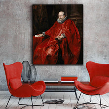 Load image into Gallery viewer, A portrait of a man dressed in red royal clothes hangs on a gray wall next to two red armchairs