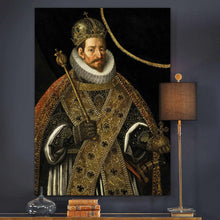 Load image into Gallery viewer, A portrait of a man dressed in historical royal clothes with a crown hangs on a dark wall next to books and a lamp
