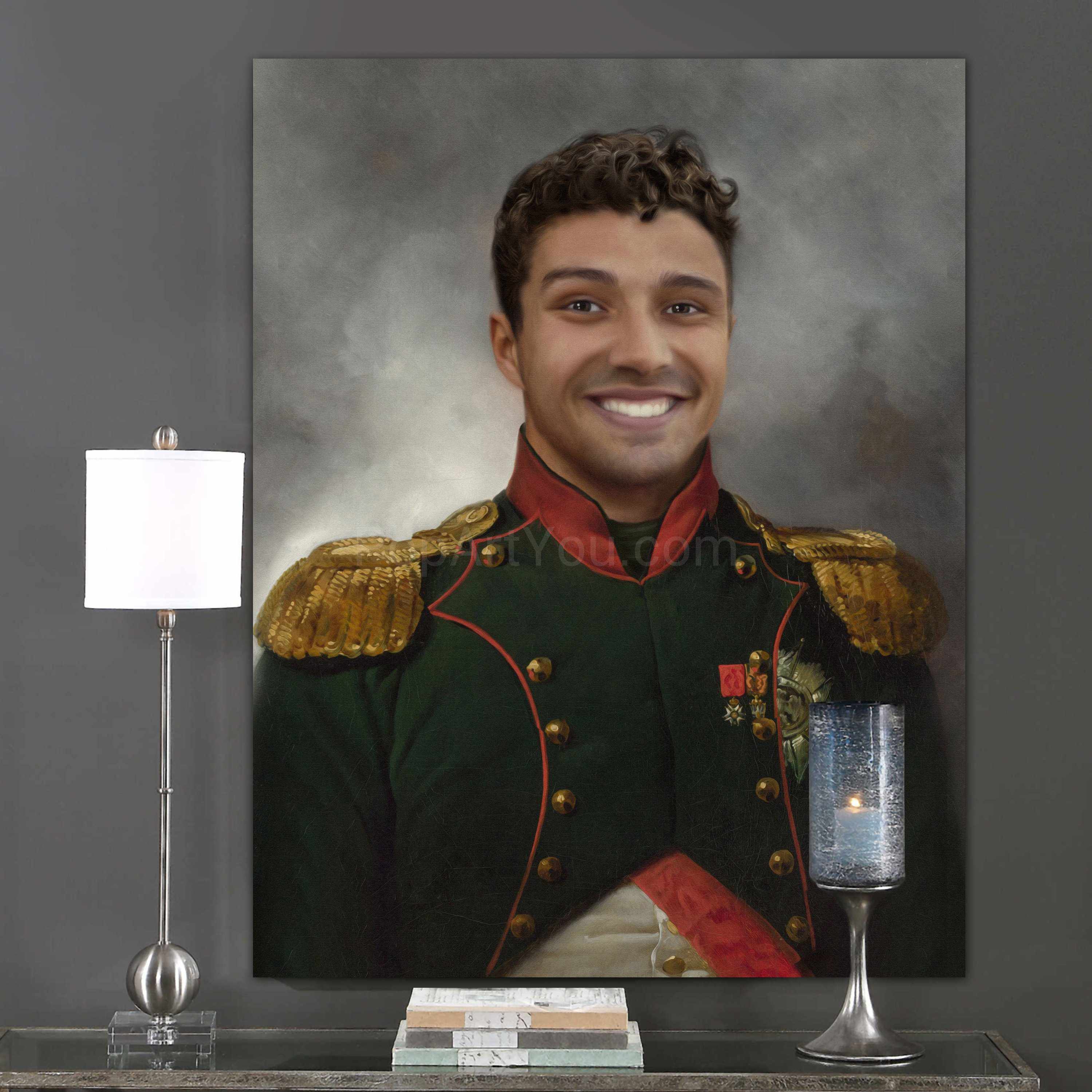 A portrait of a smiling man dressed in historical royal clothes hangs on a gray wall above a candle