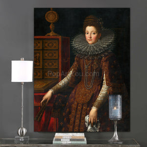 Portrait of a woman with dark hair wearing bronze royal clothes hangs on a gray wall next to a candle