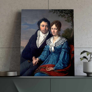 Portrait of a couple dressed in blue royal attires stands on a green table near a flowerpot