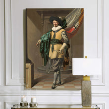 Load image into Gallery viewer, A portrait of a man dressed in historical royal clothes with a black hat hangs on a white wall above a lamp and two candles
