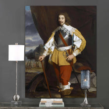 Load image into Gallery viewer, A portrait of a man with a mustache dressed in historical royal clothes hangs on a gray wall above a lamp and candle
