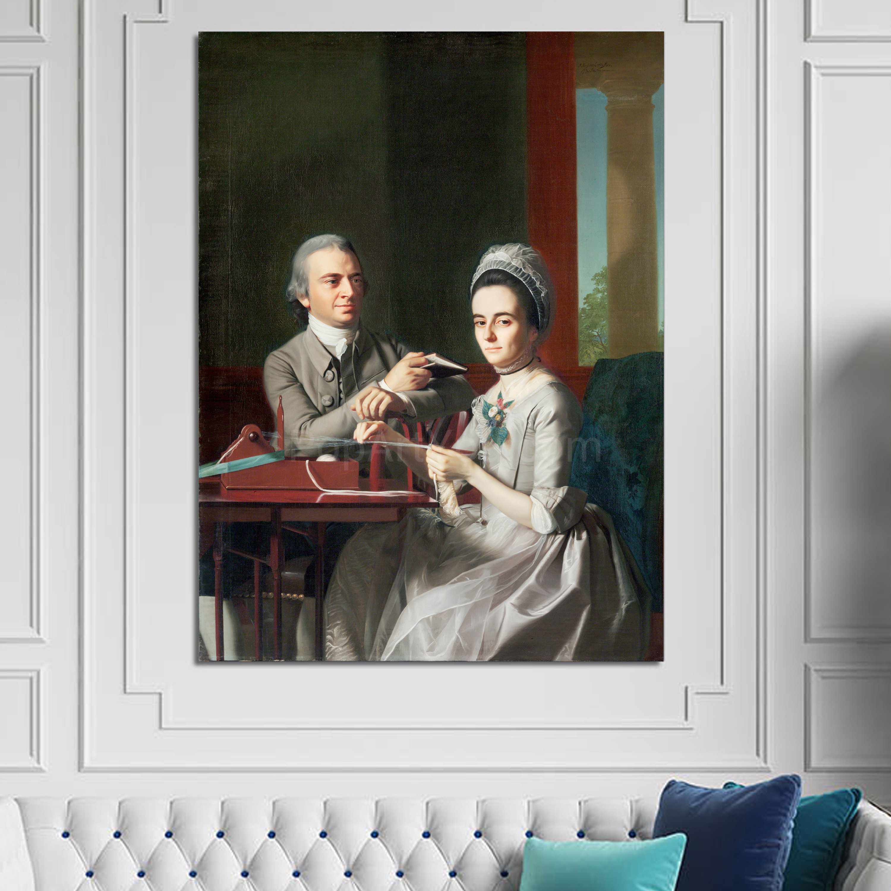 Portrait of a couple dressed in white royal attires hanging on a white wall over a white sofa