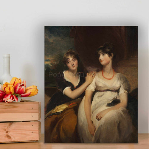 Portrait of two women dressed in regal attires standing on a wooden floor near flowers