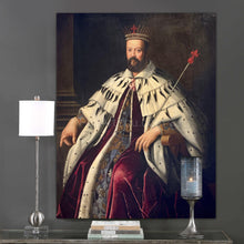 Load image into Gallery viewer, A portrait of a man dressed in regal attire with a crown hangs on a gray wall above books and a candle
