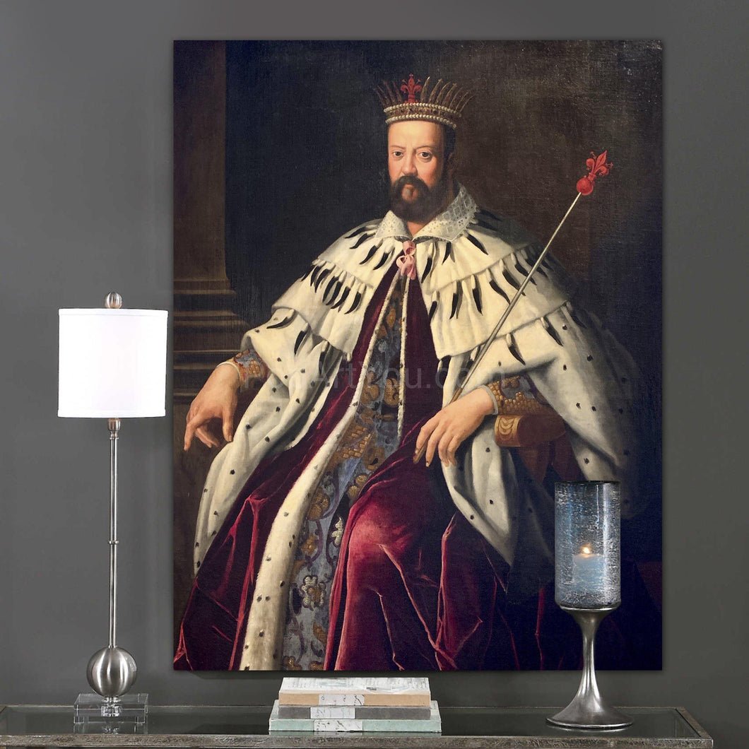 A portrait of a man dressed in regal attire with a crown hangs on a gray wall above books and a candle