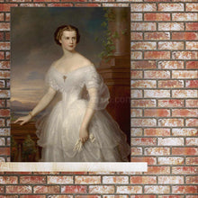 Load image into Gallery viewer, Portrait of a woman dressed in a white royal dress stands on a wooden shelf against a background of a red brick wall
