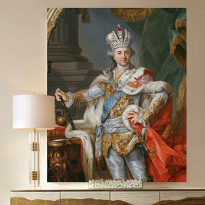 A portrait of an elderly man with long white hair dressed in historical royal clothes with a crown hangs on the beige wall next to the lamp