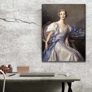 Portrait of a woman with blond hair dressed in regal attire hangs on a gray wall above a work table