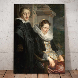 Portrait of a couple dressed in historical black clothes stands on a wooden floor near a white wall