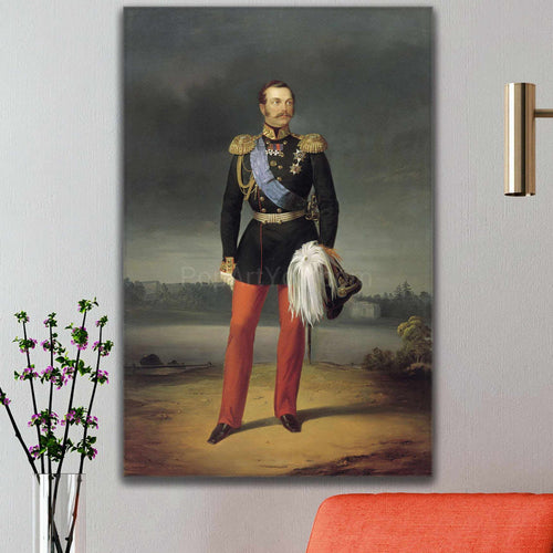 On the white wall above the red sofa hangs a portrait of a man dressed in historical royal clothes