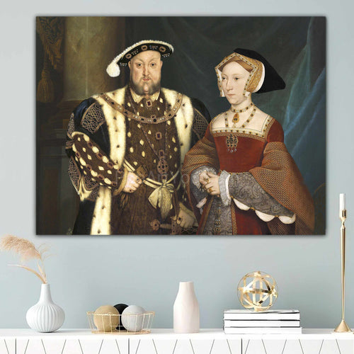 Portrait of an elderly couple dressed in historical regal attire hanging on a blue wall near a candle