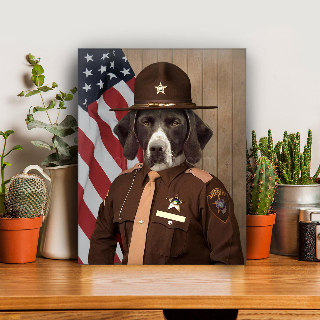 Portrait of a dog with a hat dressed in a brown sheriff's clothes stands on a wooden table near cacti