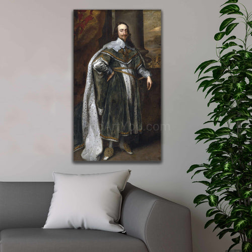 A portrait of a man dressed in renaissance royal attire hangs on a white wall next to a tree