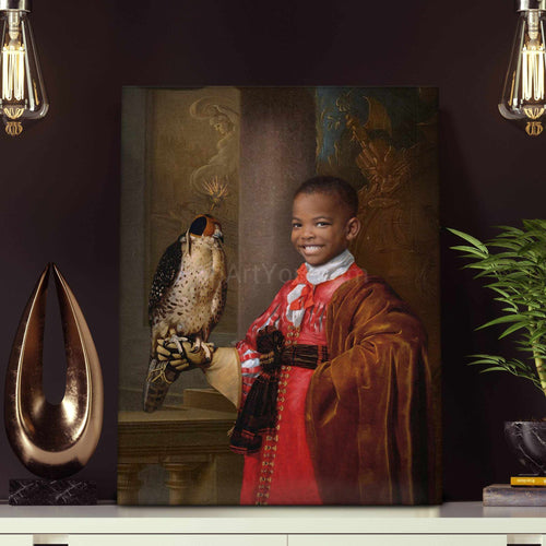 Portrait of a boy dressed in historical royal clothes holding a falcon in his hand stands on a white table