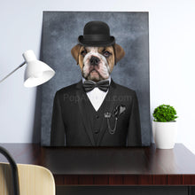 Load image into Gallery viewer, Portrait of a dog dressed in a black bowler hat stands on a wooden table near a white vase
