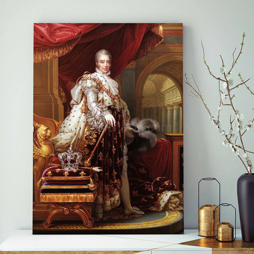 A portrait of an elderly man dressed in gold regal attire stands on a white table next to a gray vase