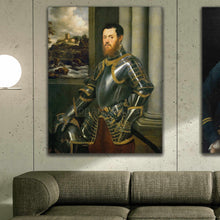 Load image into Gallery viewer, A portrait of a man dressed in historical royal clothes hangs on a gray wall above a gray sofa
