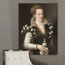 Load image into Gallery viewer, Portrait of a woman with blond hair dressed in black royal clothes hangs on a gray wall near a gray armchair
