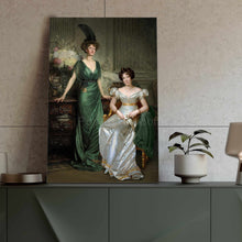 Load image into Gallery viewer, Portrait of two women with dark hair dressed in green and white dresses standing on a green table next to a pot
