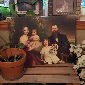 Portrait of a family dressed in historical royal clothes sitting near a tree stands on a wooden shelf