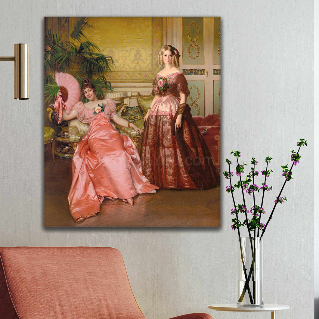 Portrait of two women dressed in royal pink dresses hanging on a white wall near a red armchair