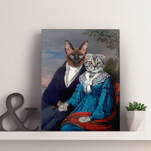 A portrait of a couple of two cats with human bodies dressed in historical royal clothes stands on a white shelf near a flowerpot