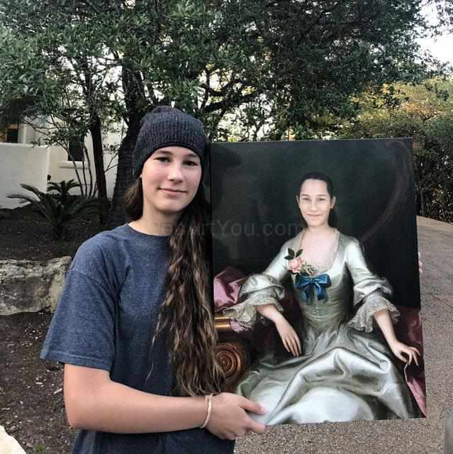 Girl holding a portrait of herself dressed in historical royal clothes