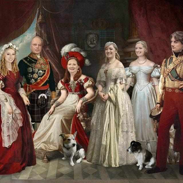 The portrait shows the royal family dressed in historical royal clothes with two dogs
