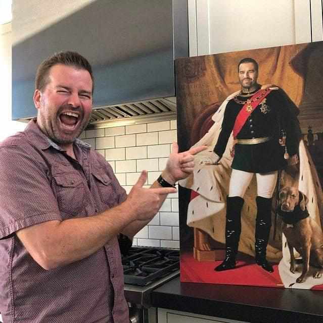 A man shows a portrait of himself dressed in a historical Ferdinand von Piloty costume