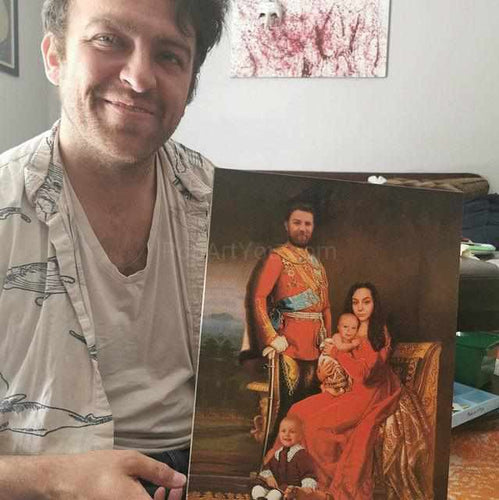 A man holding a portrait of himself with his family dressed in red royal attires