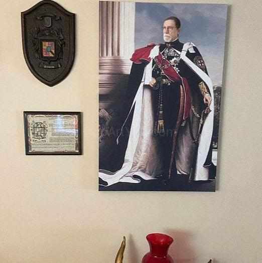 On the wall next to the clock hangs a portrait of a man dressed in royal clothes