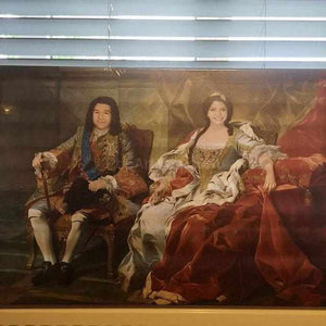 The portrait shows a couple dressed in red royal attires