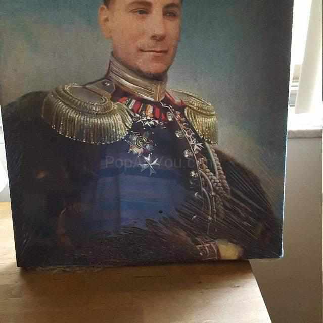 On the table is a portrait of a man dressed in a historical sergeant costume with medals and epaulets
