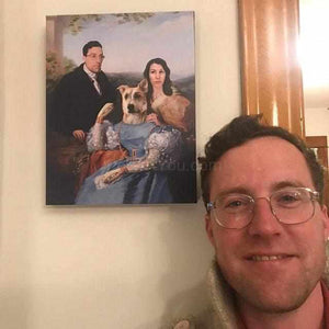 A man in glasses stands near a portrait of himself with his couple dressed in historical royal clothes and a dog with a human body
